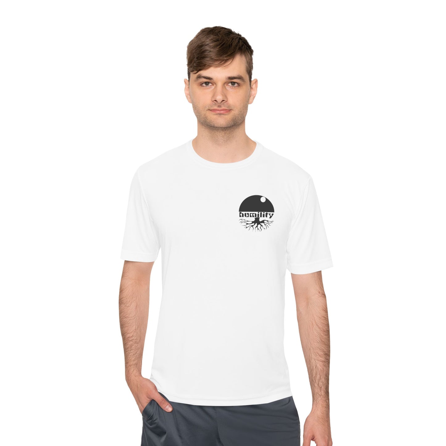 A male model wearing the Humility Moisture Wicking T-Shirt from Aethos Clothing showing the bold Humility design on the front left upper chest.