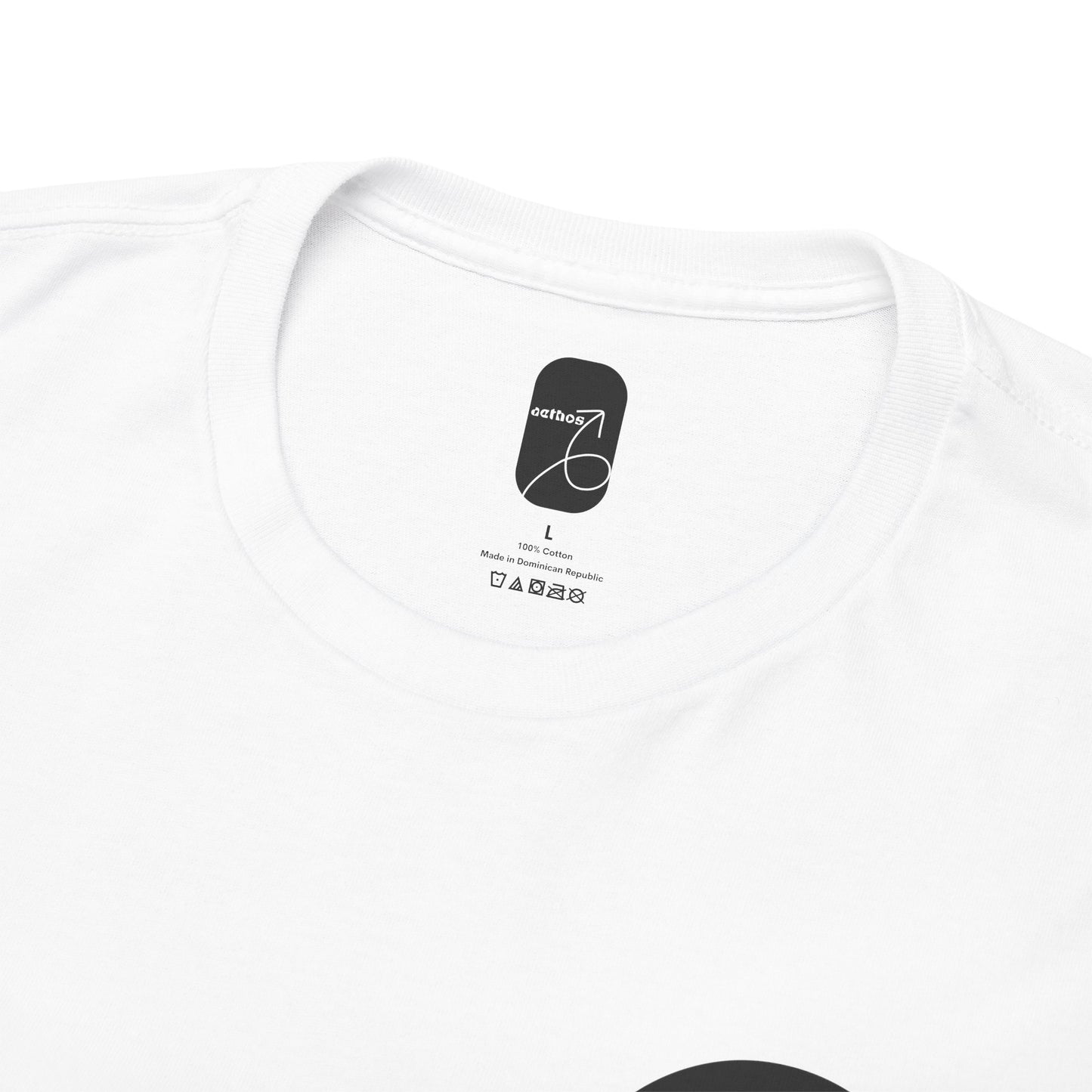A detailed view of the printed collar tag with Aethos Clothing logo and care instructions.