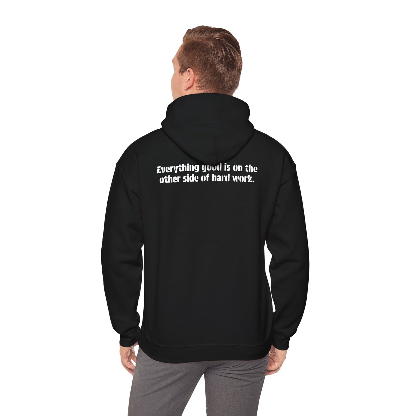 A male model wearing the black action hoodie showing the back with the meaningful message, "Everything good is on the other side of hard work."
