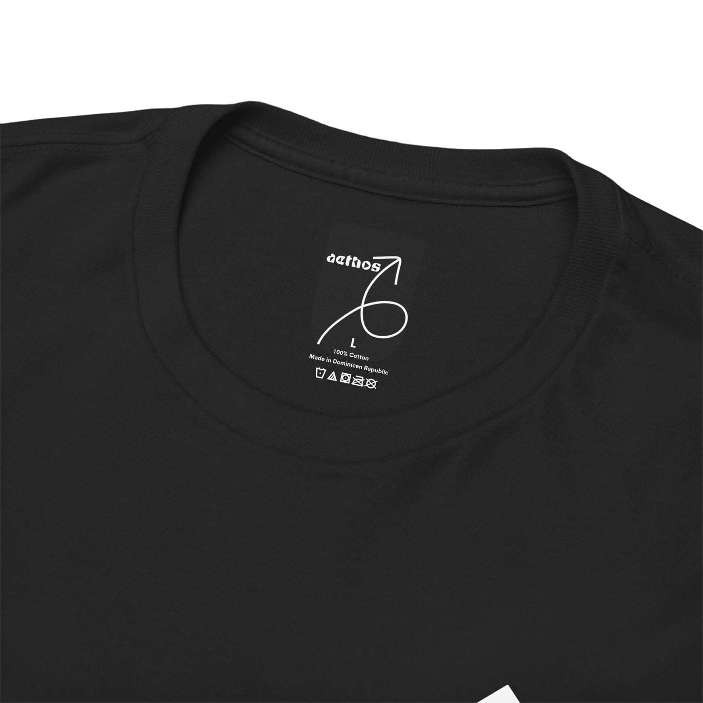 A close-up view of the inside collar of the action cotton t-shirt showing the aethos logo and t-shirt care instructions. 