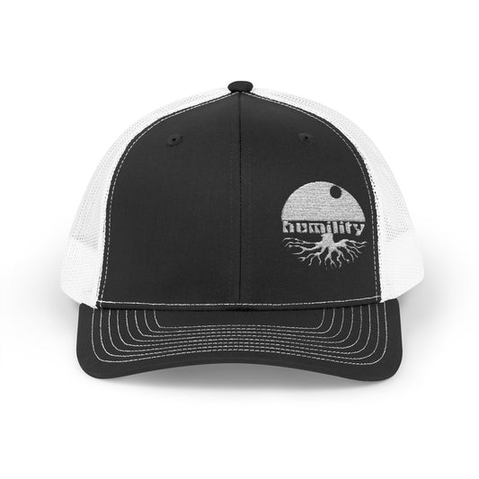 A front view of the Humility Trucker Hat by Aethos Clothing showing the embroidered humility design, stitching details and quality material. 
